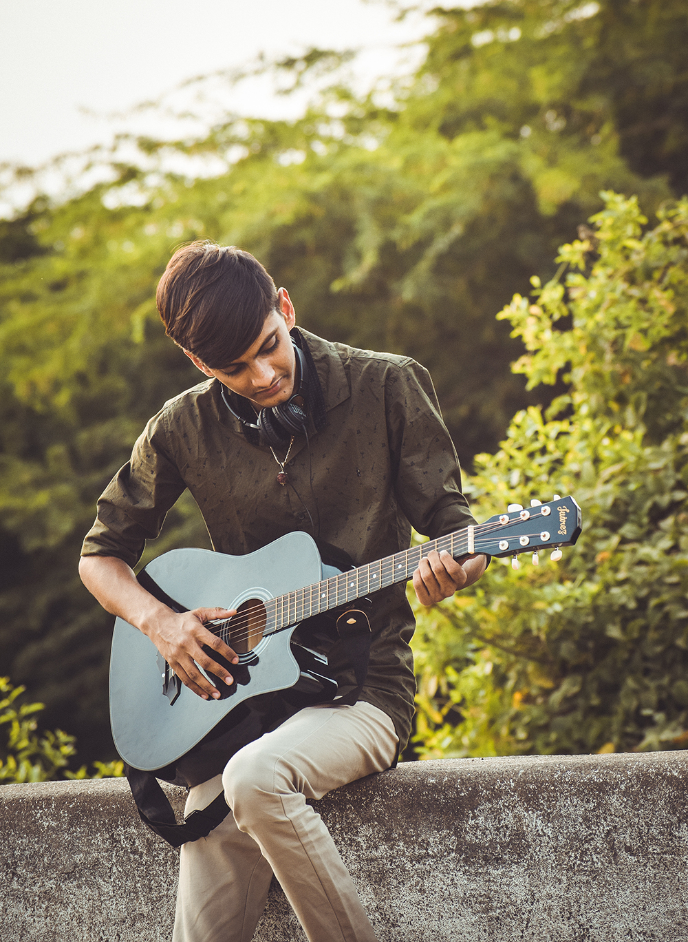 Jongen speelt gitaar in park